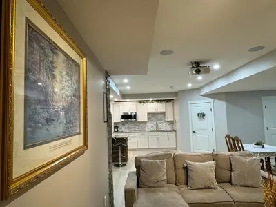 a living room with a couch and a painting on the wall at Francis' Home Stay in Calgary