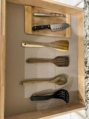 a wooden drawer with wooden utensils in it at Francis' Home Stay in Calgary