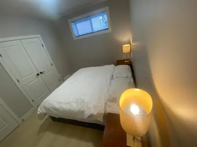 a small bedroom with a bed and a window at Francis' Home Stay in Calgary