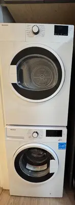 a white washer and dryer sitting next to each other at Sweet home 2 bedroom suite in Surrey