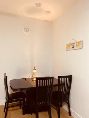 a dining room with a table and two chairs at Sweet home 2 bedroom suite in Surrey