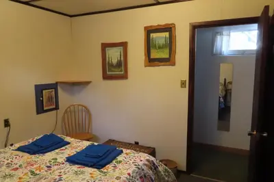 a bedroom with a bed with blue towels on it at Friendly Footprint in Golden