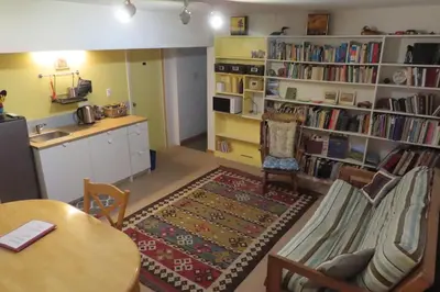 a living room with a table and chairs and bookshelves at Friendly Footprint in Golden