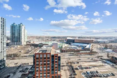 an aerial view of a city with tall buildings at The Urban Peak on the 19th Floor of the Alura in Calgary