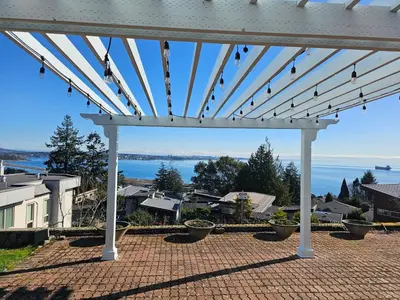 a white pergola with a view of the water at HOV B&B House -Hospitality Ocean View Victoria- in Victoria