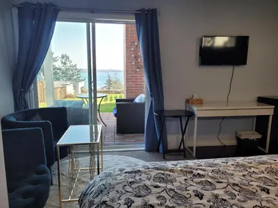 a bedroom with a bed and a view of a patio at HOV B&B House -Hospitality Ocean View Victoria- in Victoria