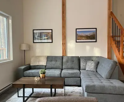 a living room with a couch and a table at Valley Edge Lodge in Golden
