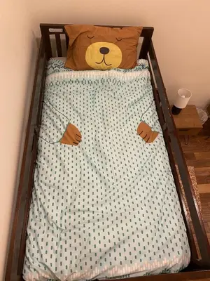 a teddy bear laying on top of a bed at Bluesky Lodge in Golden