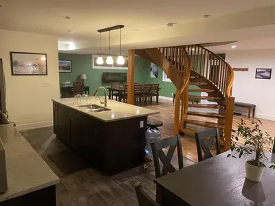 a kitchen and dining room with a wooden staircase at Bluesky Lodge in Golden