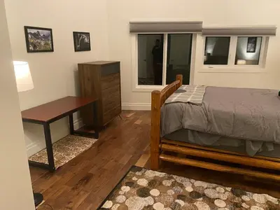a bedroom with a bed and a desk and a table at Bluesky Lodge in Golden