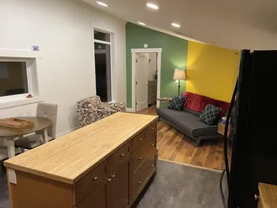 a living room with green and yellow walls and a couch at Bluebird Nest in Golden