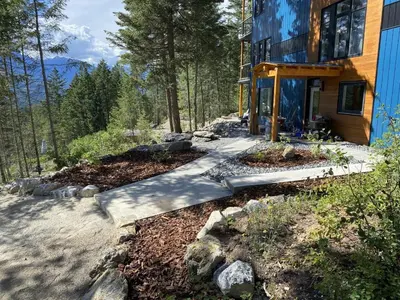 a walkway leading to a house in the woods at Bluebird Nest in Golden