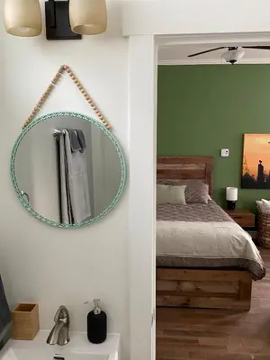a bedroom with a bed and a mirror on the wall at Birch Suite in Golden