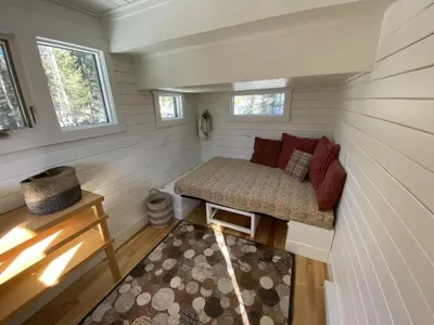 a small room with a couch in a tiny house at Alder House in Golden