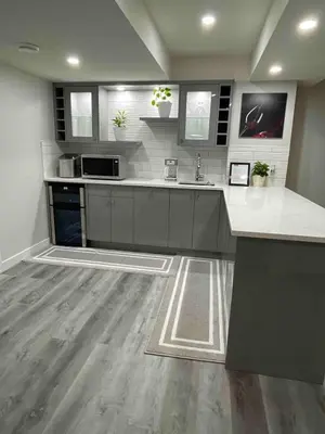 a large kitchen with white counters and a counter top at HansBnB near Airport in Calgary