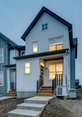 a gray house with a front porch and stairs at Neutral Living 6Beds 4Bedrooms and Bonus Room Free Parking in Calgary