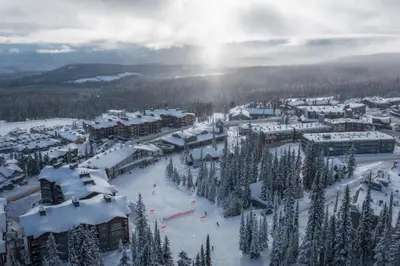 a town covered in snow with trees and buildings at Southpoint 25 Two Bdrm Ski In Out w Hot Tub in Big White
