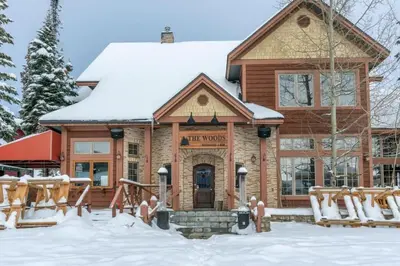 a lodge in the snow in front of a building at Southpoint 25 Two Bdrm Ski In Out w Hot Tub in Big White