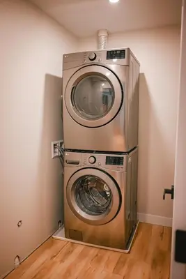 a washer and dryer in a corner of a room at Courtenay Luxe Suite in Courtenay