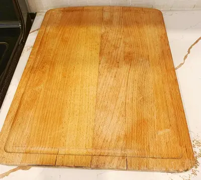 a wooden cutting board sitting on top of a counter at Cozy Guest Suite Near University of Alberta, Southgate Mall, and Downtown in Edmonton