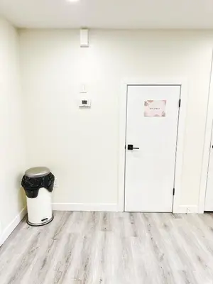 an empty room with a door and a trash can at Cozy Guest Suite Near University of Alberta, Southgate Mall, and Downtown in Edmonton