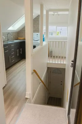 a small kitchen with a sink and a counter at Quaint Attic Suite with Heated Pool Year-Round in Victoria