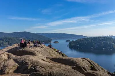 a group of people sitting on top of a rocky mountain at North Vancouver Retreat, Cozy & Central, Walk to Lonsdale & Seabus in North Vancouver