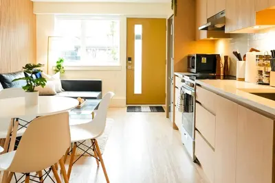 a kitchen and dining room with a table and chairs at North Vancouver Retreat, Cozy & Central, Walk to Lonsdale & Seabus in North Vancouver