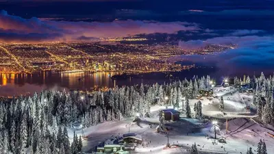 an aerial view of a city in the snow at night at North Vancouver Retreat, Cozy & Central, Walk to Lonsdale & Seabus in North Vancouver
