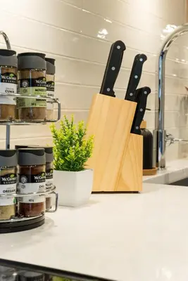 a kitchen counter with a cutting board and knives at North Vancouver Retreat, Cozy & Central, Walk to Lonsdale & Seabus in North Vancouver
