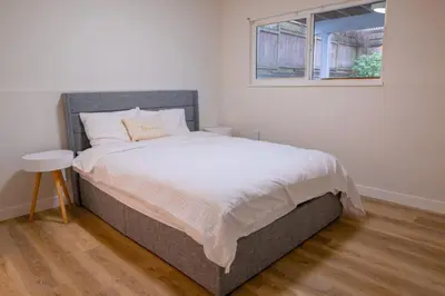 a bedroom with a large bed with a window at The Vida 1 Bed Pet-Friendly in Abbotsford