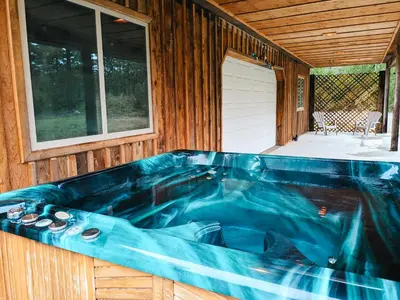 a jacuzzi tub on the side of a house at Quirky Farm Stay at Flower Beds Farm - Hot Tub in Qualicum Beach