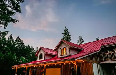 a house with a red roof with lights on it at Quirky Farm Stay at Flower Beds Farm - Hot Tub in Qualicum Beach