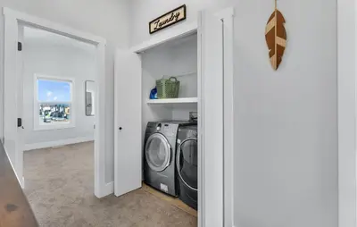 a laundry room with a washer and dryer at Your Pleasant stay in 3 bedroom House in Saddle-Ridge in Calgary