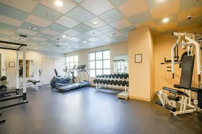 a gym with treadmills and machines in a room at Yaletown Gorgeous Unit Steps from the Beach in Vancouver