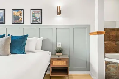 a bedroom with a bed and a sink at Charming & Cozy 1-Bedroom Retreat in Canmore