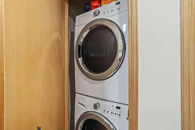 a washing machine and a dryer in a closet at Charming & Cozy 1-Bedroom Retreat in Canmore