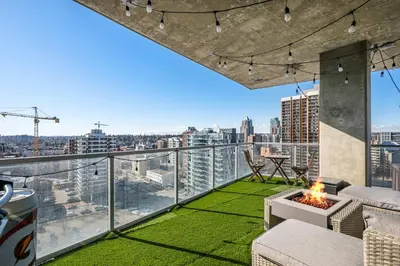 a balcony with a view of a city at Urban Oasis - 2BR Condo Downtown Large Balcony in Calgary