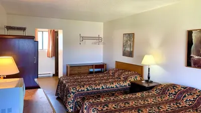 a hotel room with two beds and two lamps at Hotel viewmont in Logan Lake