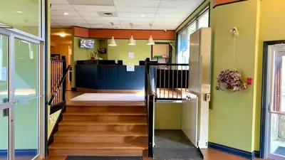a hallway with a stairway leading into a room at Hotel viewmont in Logan Lake