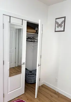 a room with a door open to a closet at Charming Stay & Cozy Retreat by Bansari Homes in Edmonton- YEG in Edmonton