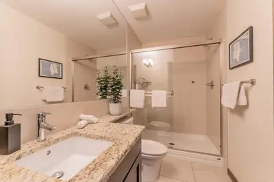 a bathroom with a sink and a shower and a toilet at Breathtaking Luxury 3Bd Penthouse Pool and Hot Tub in Canmore