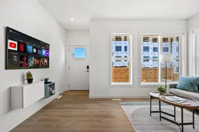 a living room with a couch and a table at Luxury Aspen 2BR Home with Double Garage Car Parking in Calgary