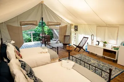a room with two beds in a tent at Haida Gwaii Glamping in Tlell