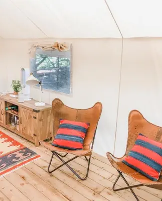 two chairs sitting in a room with a desk at Haida Gwaii Glamping in Tlell