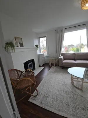 a living room with a couch and a fireplace at Two bedroom coastal retreat in Victoria