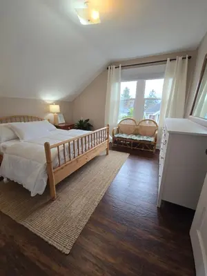 a bedroom with a large bed and a large window at Two bedroom coastal retreat in Victoria