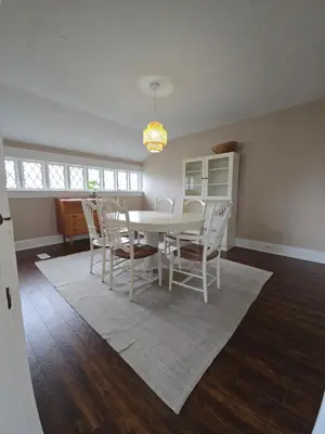 a dining room with a white table and chairs at Two bedroom coastal retreat in Victoria