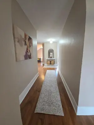 an empty hallway with a rug on a hard wood floor at Two bedroom coastal retreat in Victoria