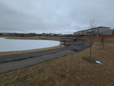 a walkway next to a body of water at lovely 2bed & 1 Bath Basement Suite for 4 guests in Calgary